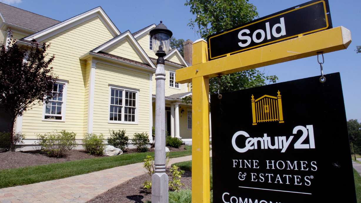 A sold sign is posted outside a newly constructed luxury home in Wellesley, Mass., Aug. 25, 2009.