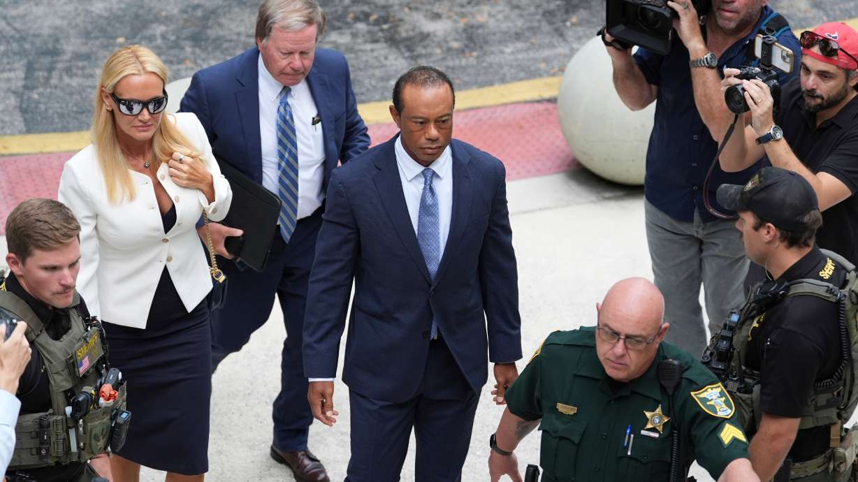Golfer Tiger Woods, right, arrives with Vanessa Trump, left, for Woods' plea conference hearing in a DUI case stemming from a rollover crash in Florida in March, Wednesday, Sept. 2, 2026, in Stuart, Fla.