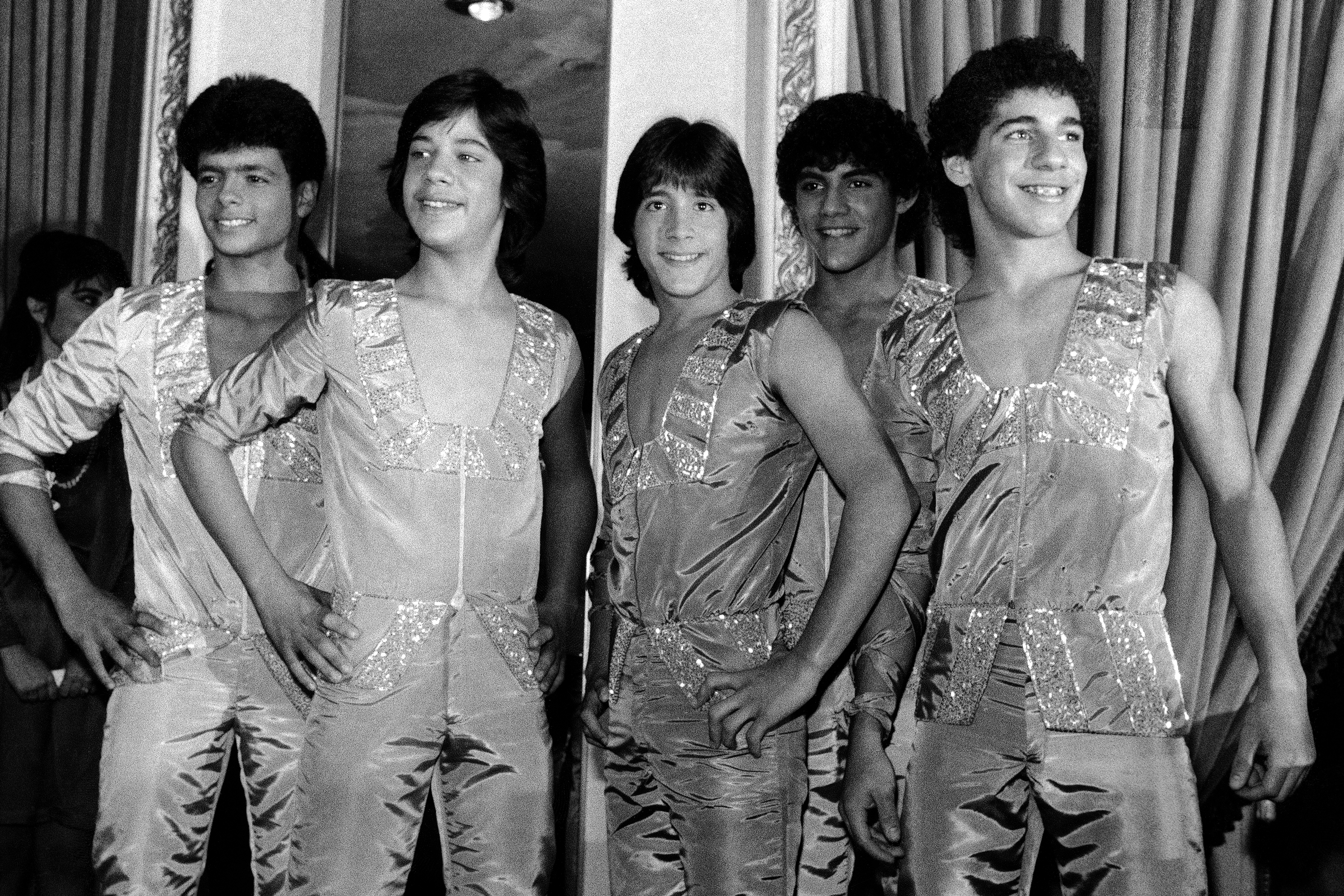 FILE - Members of the music group "Menudo," from left, Robby Rosa (Draco Rosa), Ray Reyes, Roy Roselló, Charlie Massó and Ricky Meléndez pose during a reception in their honor in New York on Feb. 10, 1984. 