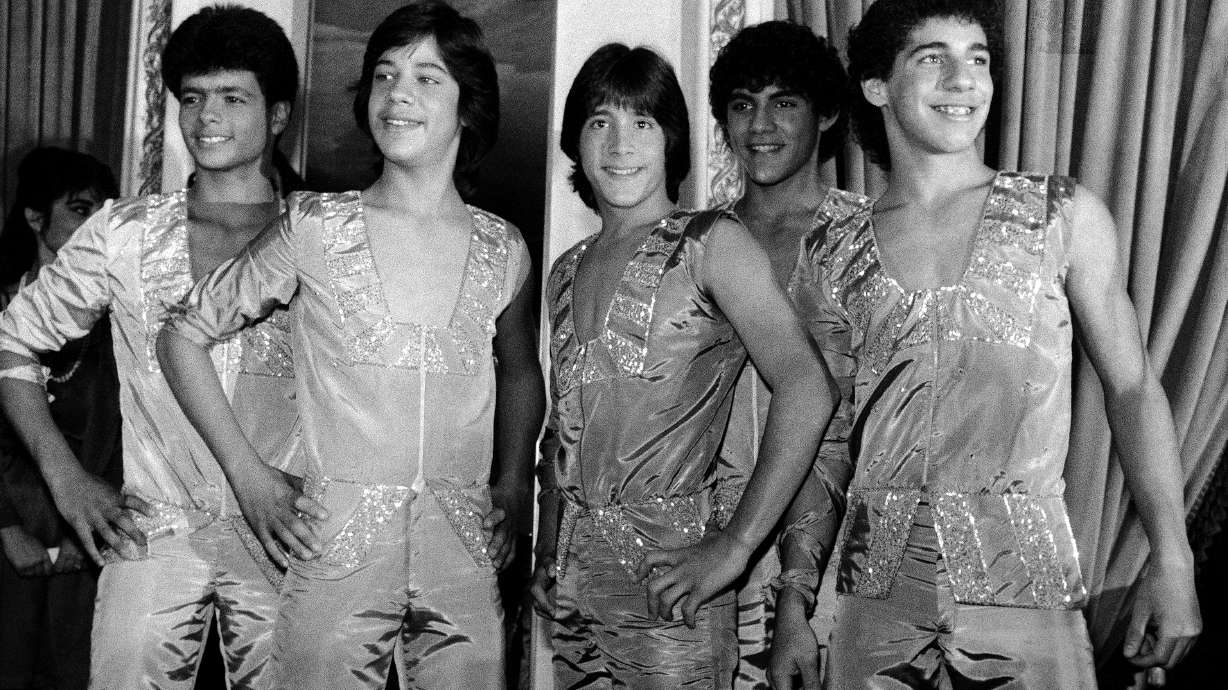 FILE - Members of the music group "Menudo," from left, Robby Rosa (Draco Rosa), Ray Reyes, Roy Roselló, Charlie Massó and Ricky Meléndez pose during a reception in their honor in New York on Feb. 10, 1984.