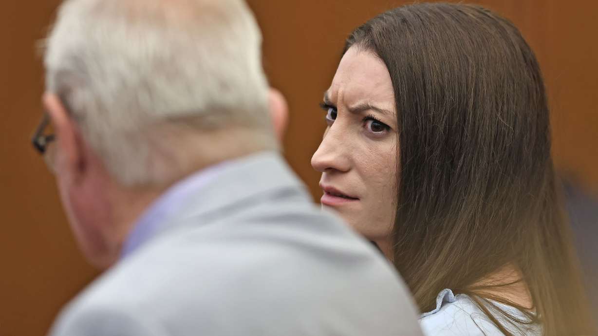Lindsay Clancy reacts to news that a woman was arrested for recording images of the jury at Plymouth Superior Court in Plymouth, Mass., Wednesday. Jurors were once again deadlocked during a fifth day of deliberations in her trial.
