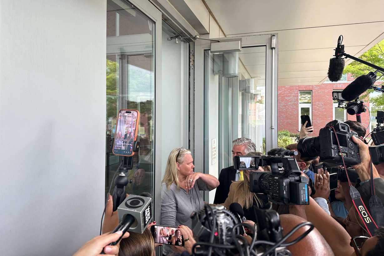 Dawn Light is questioned by reporters as she leaves her arraignment where she was charged with intimidation in connection with the Lindsay Clancy's murder trial in Plymouth, Mass., Wednesday. Light was arrested on Tuesday for allegedly filming the courthouse.