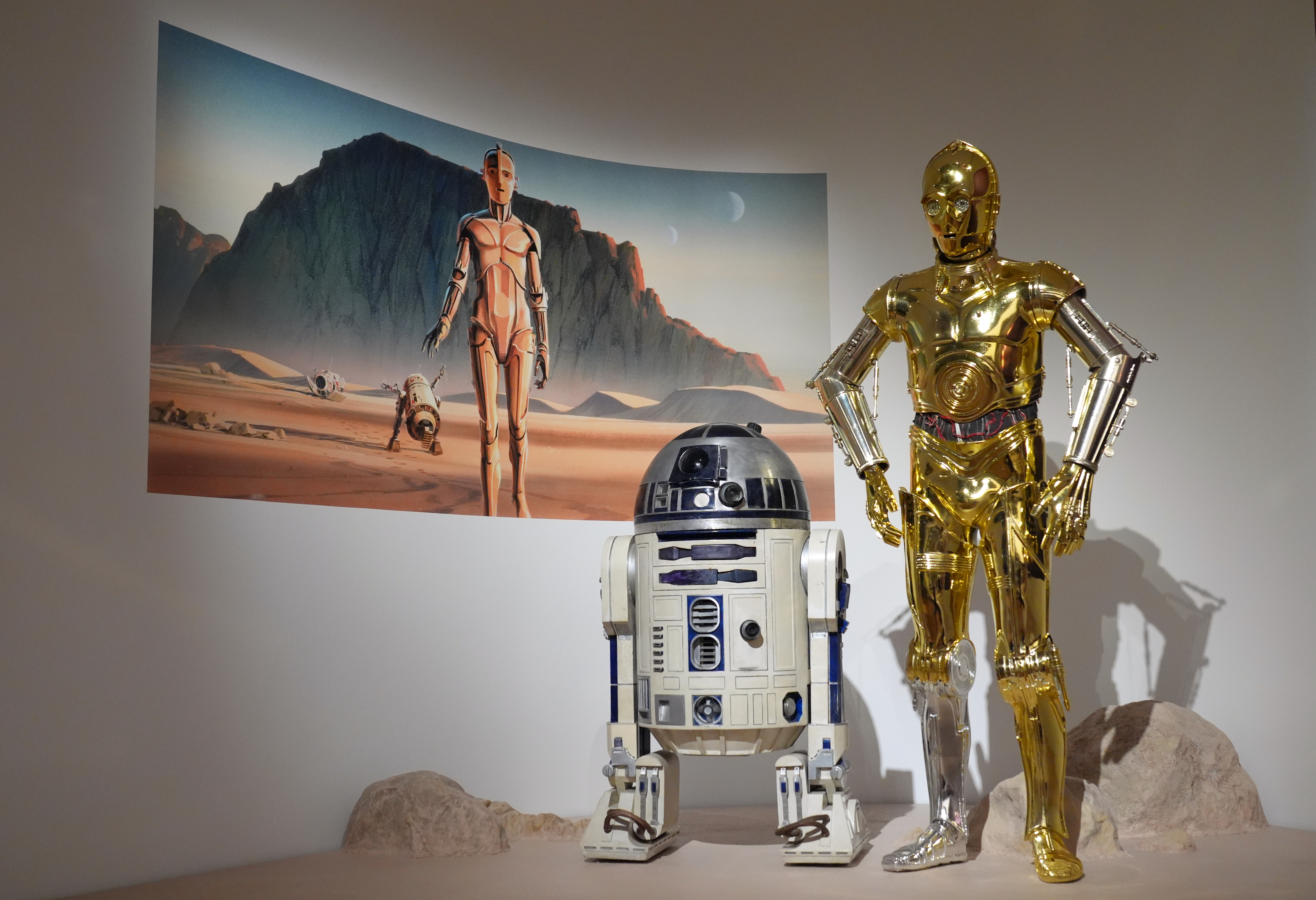 Production designer Norman Reynolds' robot R2-D2, left, and John Mollo's costume for the C-3PO character from the "Star Wars" franchise are displayed in the Cinema Gallery during a preview of the Lucas Museum of Narrative Art on Monday, Aug. 31, 2026, in Los Angeles. 