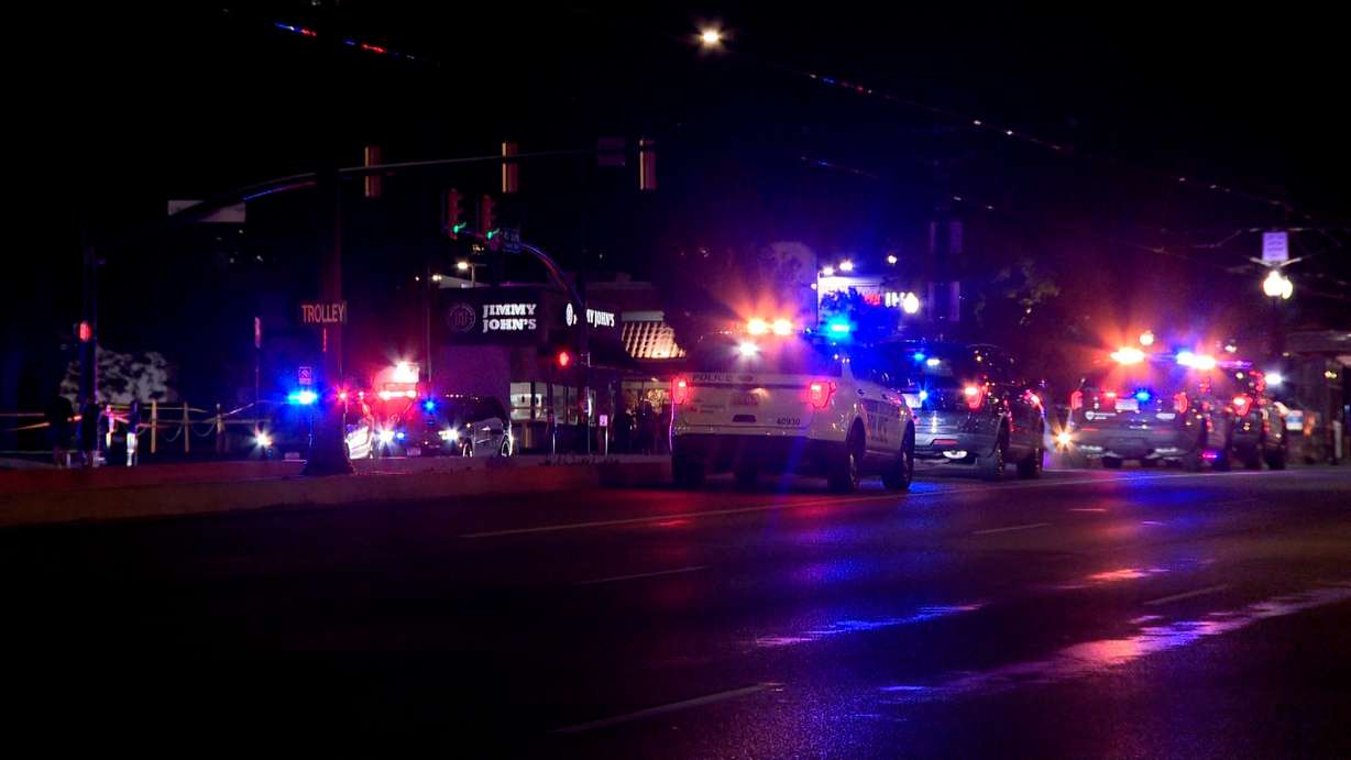 The scene of a shooting is pictured on 400 South in Salt Lake City on Monday, after a man allegedly fled from police and was shot by responding officers, according to charging documents.
