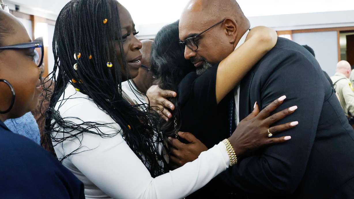 Friends and family members of rapper Tupac Shakur, including his sister Sekyiwa Shakur, second left, line up to hug Chief Deputy District Attorney Binu Palal, right, after a jury found Duane Davis guilty of first-degree murder in his trial related to the 1996 killing of rapper Tupac Shakur, at Clark County District Court Regional Justice Center, Monday, Aug. 31, 2026, in Las Vegas.