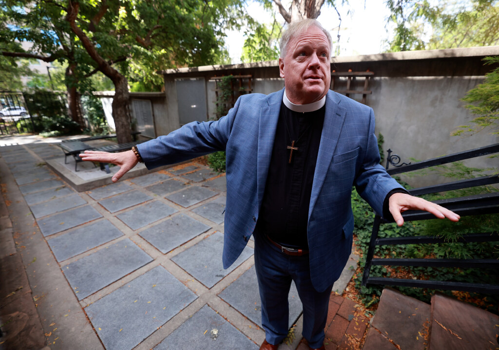 The Rev. Steven Smith, Cathedral Church of St. Mark priest in charge, shows a columbarium outside of the Episcopal Cathedral Church of St. Mark in Salt Lake City on Tuesday. People do not need to be Episcopal to have their ashes buried here.