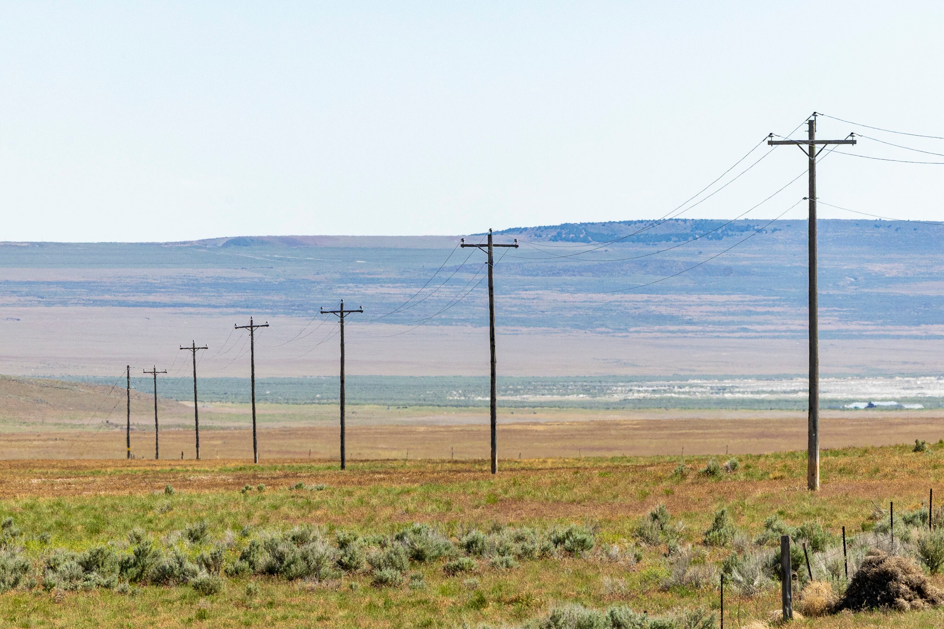 Power lines stand on land proposed to be used for the Stratos Project data center in the Hansel Valley area of Box Elder County on May 12. Researcher Shon Hiatt says data centers could have an impact on power prices.