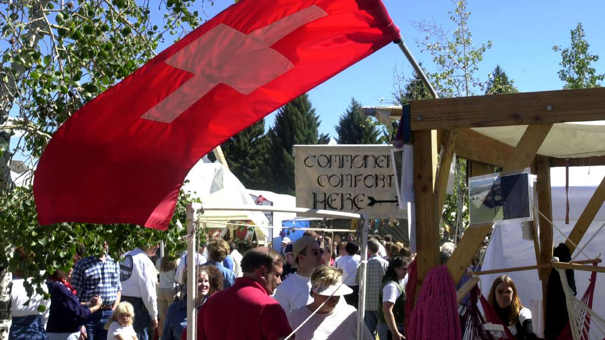 Thousands walk through the vendor booths during Swiss Days Festivities in Midway Sept. 2, 2000. The festival opens Friday and Saturday.