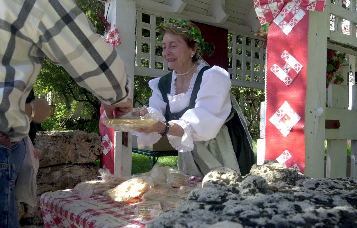June Tatton hands out samples of Swiss pastries she is selling during Swiss Days Festivities in Midway, Sept. 2, 2000.