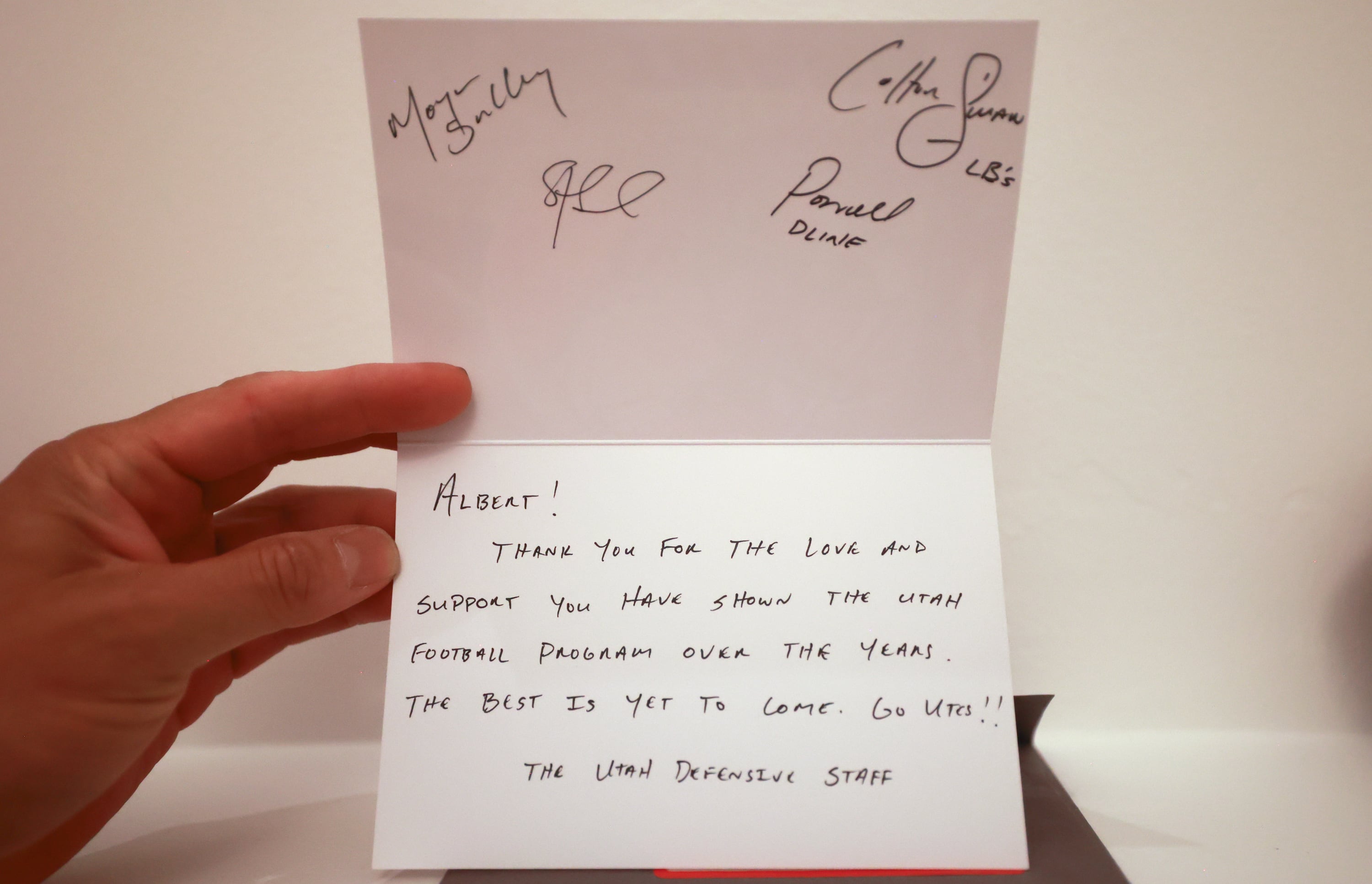 University of Utah football superfan Albert Gamboa shows a note from the Utes defensive staff at home in Riverton on Aug. 24.