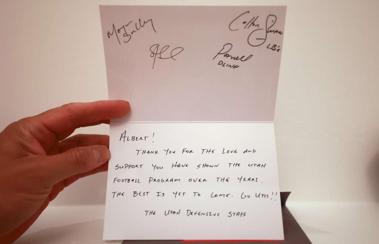 University of Utah football superfan Albert Gamboa shows a note from the Utes defensive staff at home in Riverton on Aug. 24.