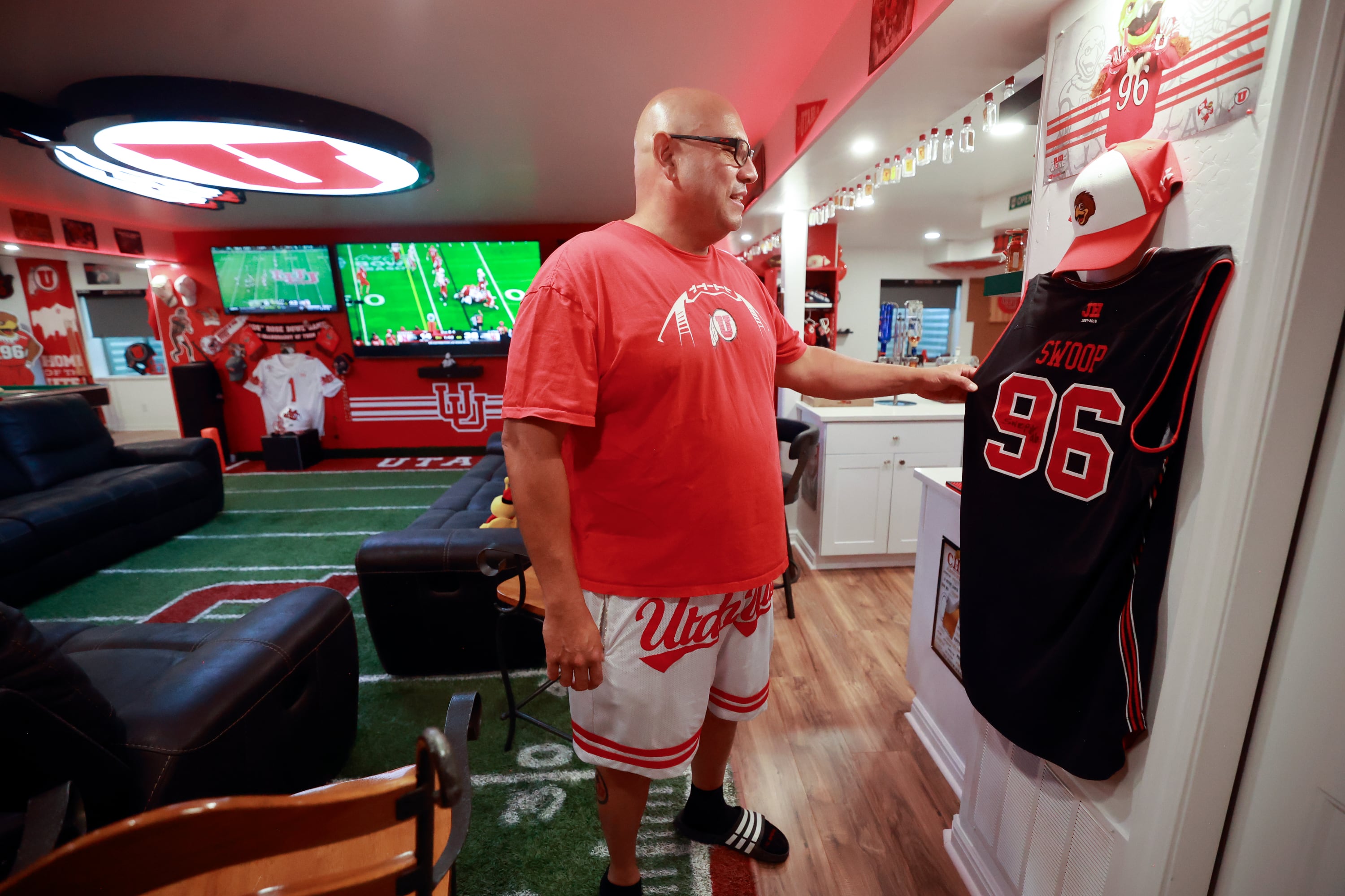 University of Utah football superfan Albert Gamboa shows a Swoop jersey and many other University of Utah-themed decorations in his house in Riverton on Aug. 24.