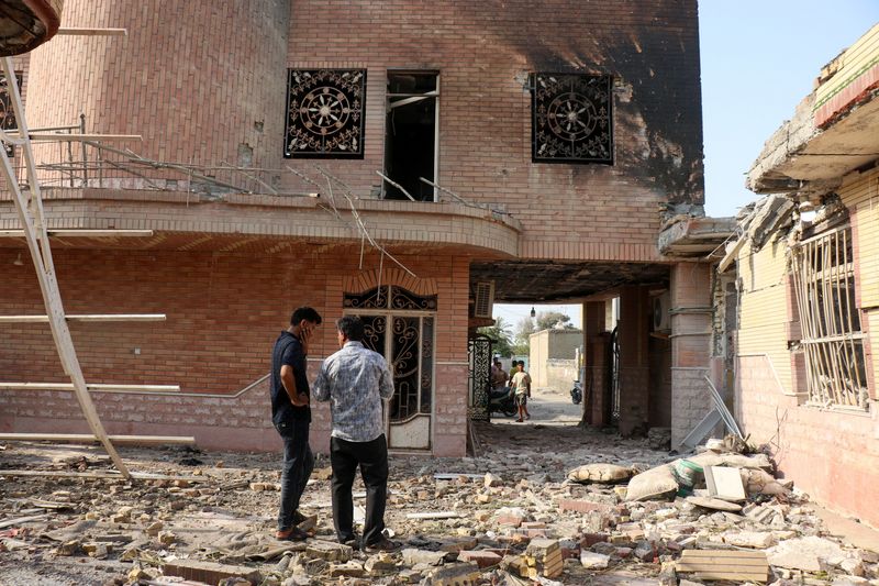 Rubble lies around damaged houses following a reported attack near a wedding gathering in Kuhistik, Sirik, Iran, on Tuesday.