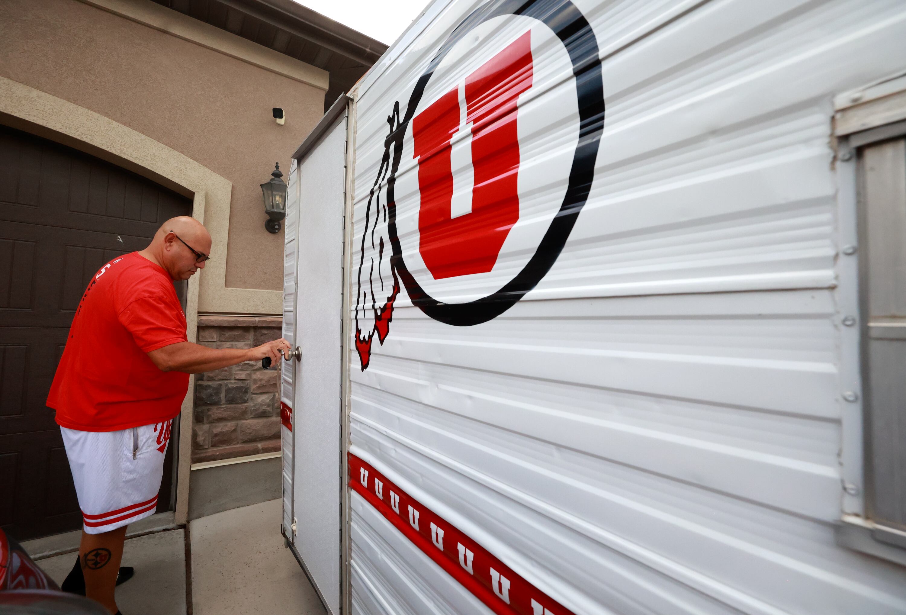 University of Utah football superfan Albert Gamboa shows his Utes-themed camping trailer that is used for tailgating in Riverton on Aug. 24.