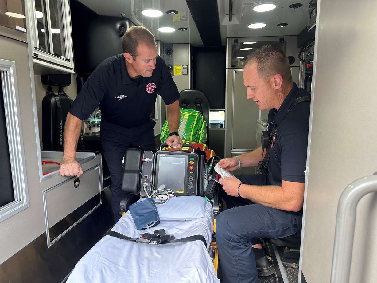 Capt. Phil Pifer and firefighter Greg Cox demonstrate what was used to save the boy's life.