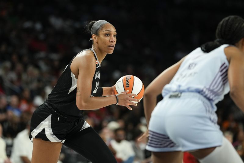 Aug 28, 2026; Las Vegas, Nevada, USA;  Las Vegas Aces center A'ja Wilson (22) controls the ball against the Toronto Tempo during the second quarter of a WNBA basketball game at Michelob Ultra Arena.