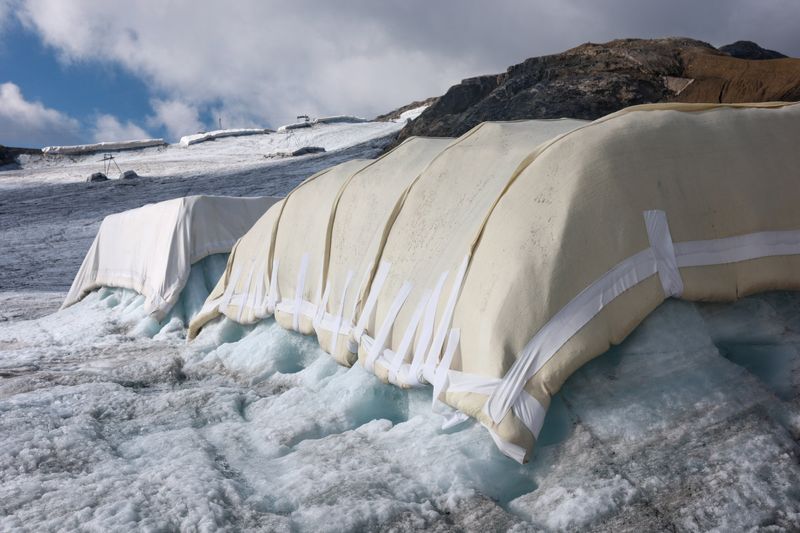 A sheep wool-covered snow protection test site is pictured during a press conference presenting the results of the "Keep It Wool" glacier protection experiment in Les Diablerets, Switzerland, September 2, 2026. The project tested wool coverings on the Tsanfleuron Glacier at Glacier 3000 as a biodegradable alternative to synthetic geotextiles used in snow farming to help slow glacier melt. Much of the wool produced in Switzerland is not commercially used and is often composted or incinerated.