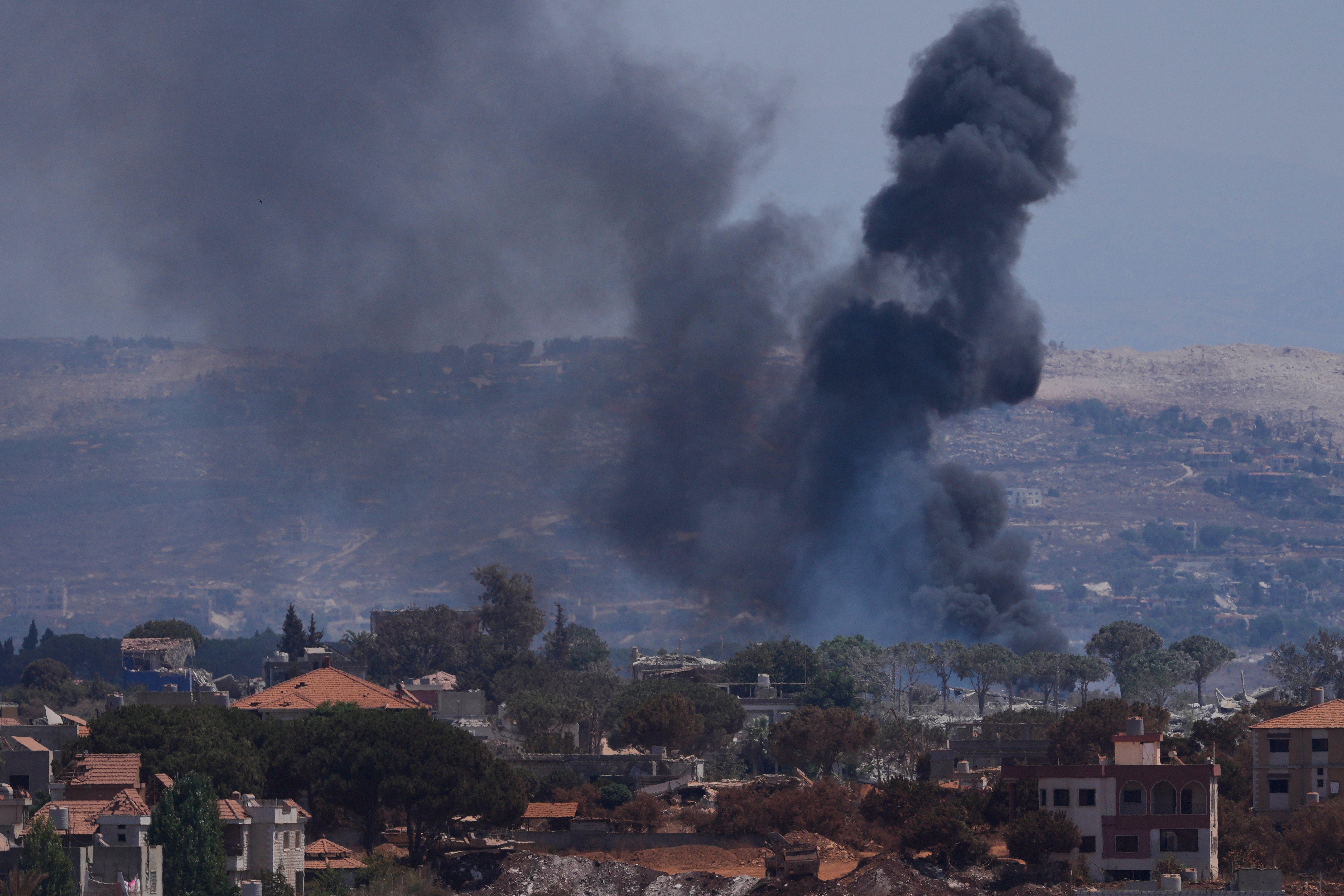 Smoke rises as Israeli forces demolish homes in Zawtar al-Sharqiyah, southern Lebanon, Aug. 23. A Lebanese man held prisoner in Israel was released on Thursday.