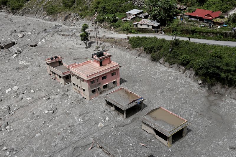 An aerial view shows houses standing amid debris during a helicopter flight from Nuwakot to Rasuwa following the deadly flash floods and mudslides in Nepal, September 3, 2026.