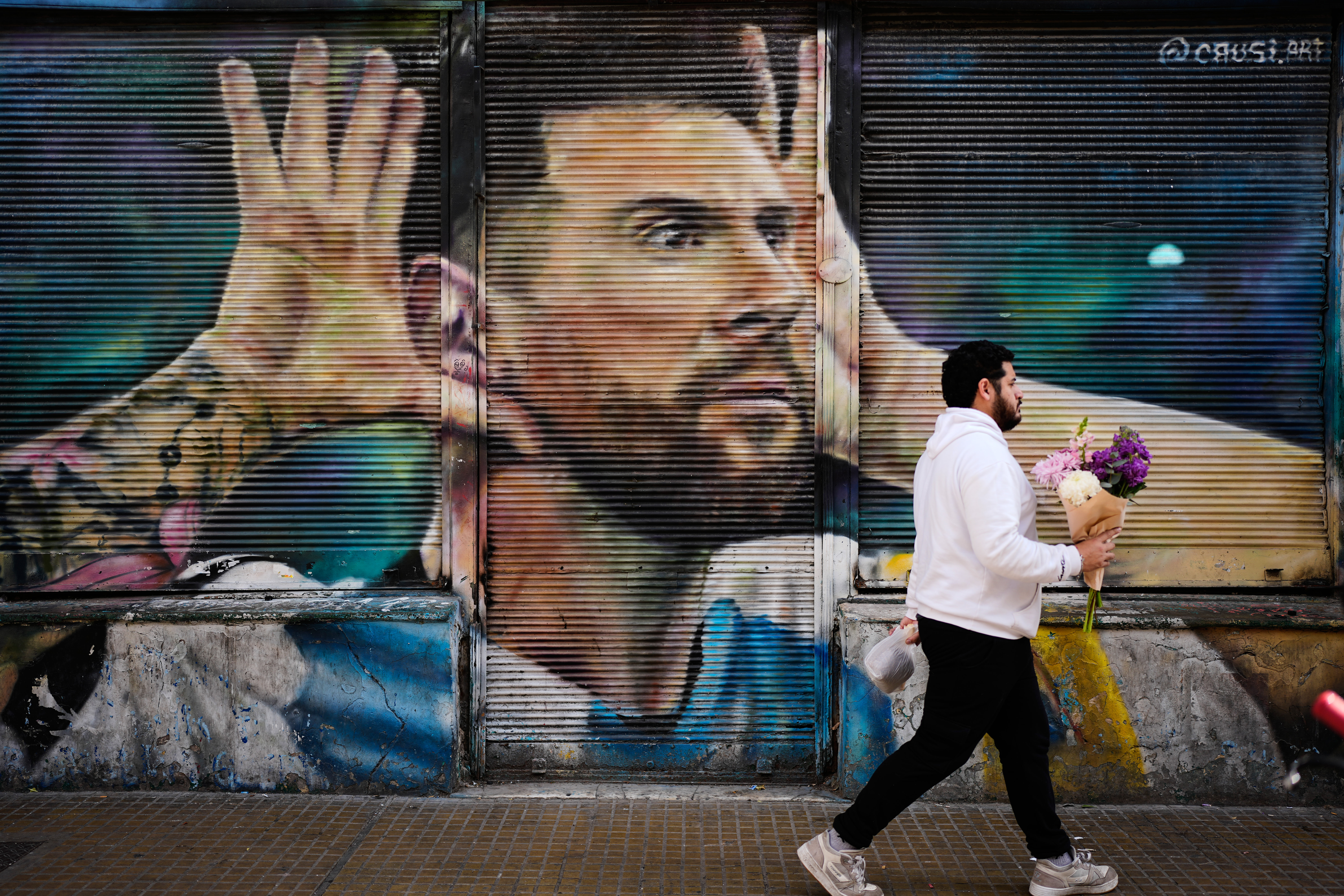 A man walks past by a mural of Argentina soccer player Lionel Messi in Buenos Aires, Argentina, Monday, Aug. 31, 2026. 