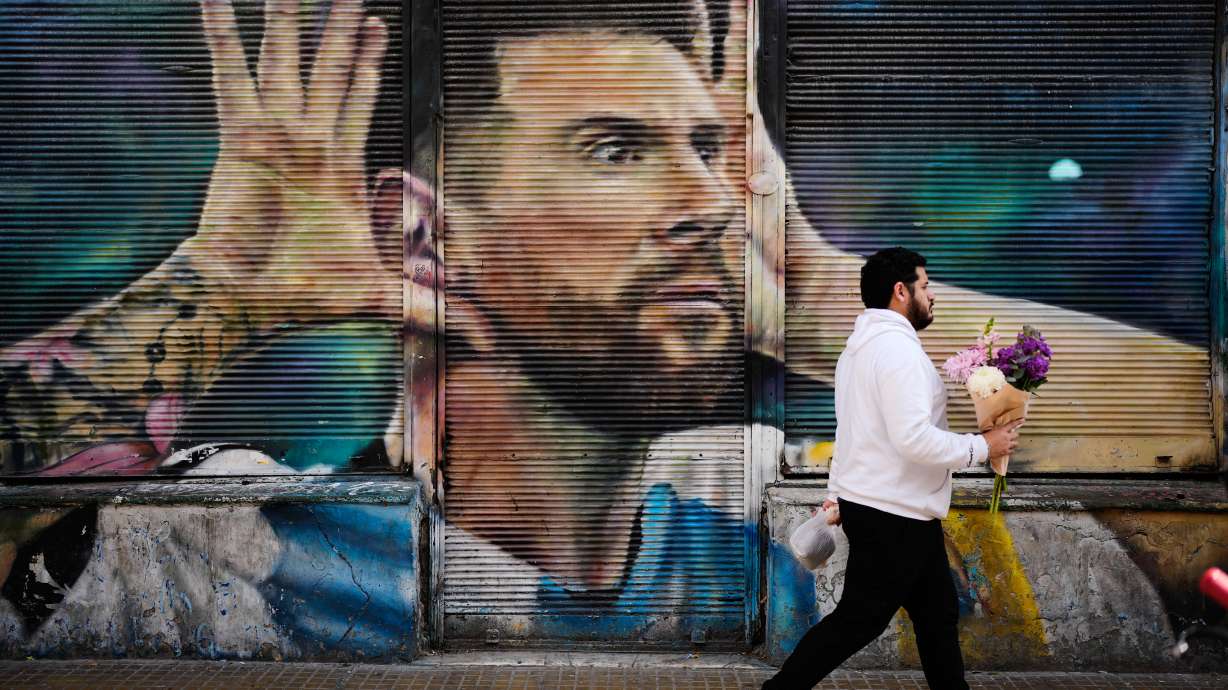 A man walks past by a mural of Argentina soccer player Lionel Messi in Buenos Aires, Argentina, Monday, Aug. 31, 2026.