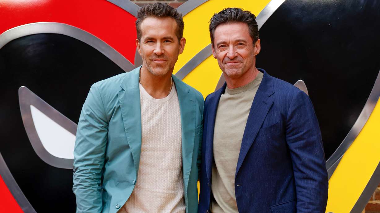 FILE - Ryan Reynolds, left, and Hugh Jackman pose for photographers upon arrival at the screening of the film "Deadpool & Wolverine" on July 11, 2024 in London.
