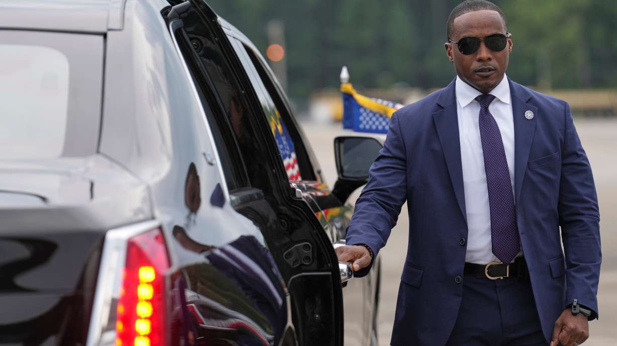 A member of the U.S. Secret Service stands before President Donald Trump arrives to board his limousine at Myrtle Beach International Airport in Myrtle Beach, S.C., Friday, Aug. 21.