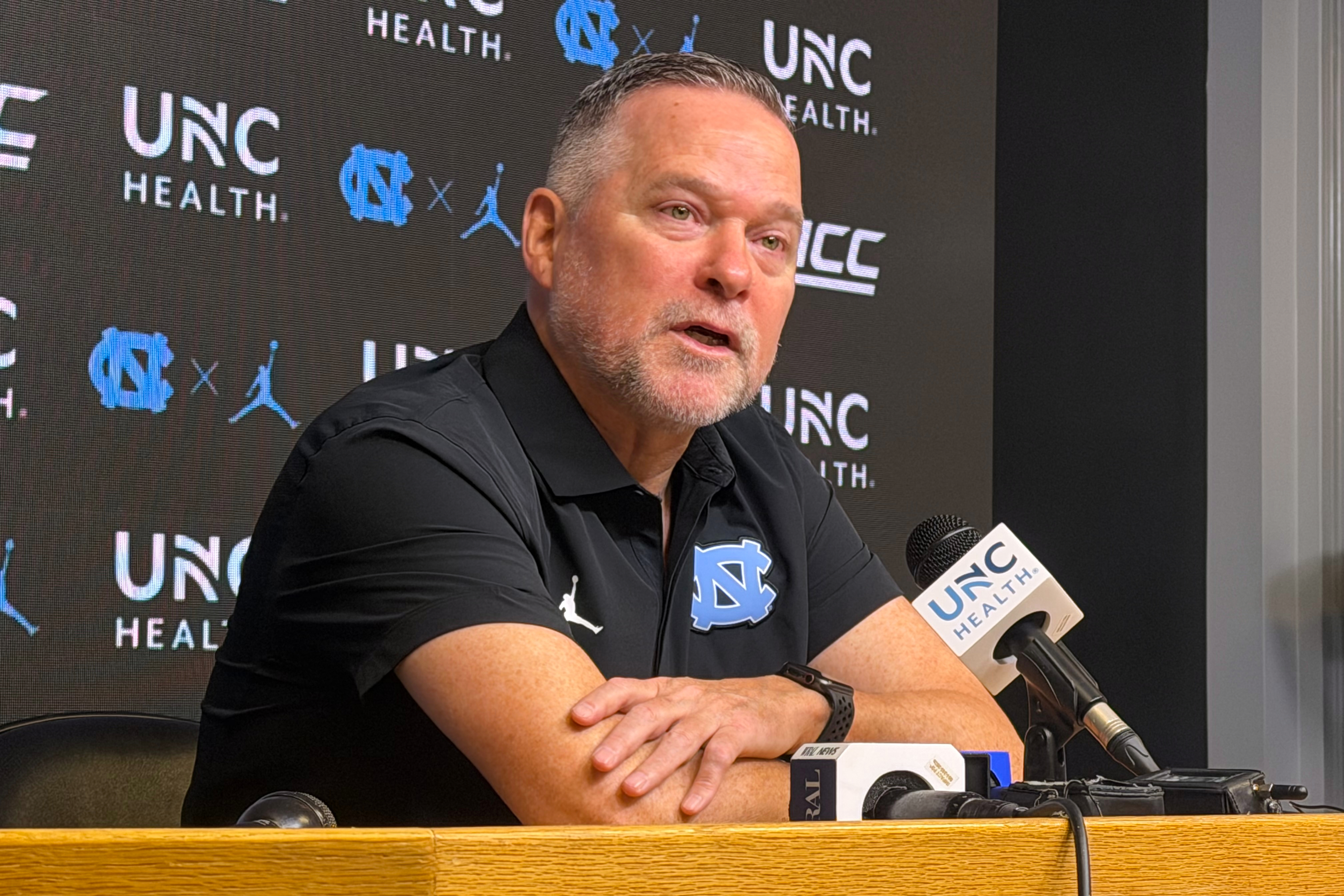 In this photo taken with a smartphone, North Carolina men's basketball head coach Michael Malone speaks during a news conference Thursday, Sept. 3, 2026, in Chapel Hill, N.C. 