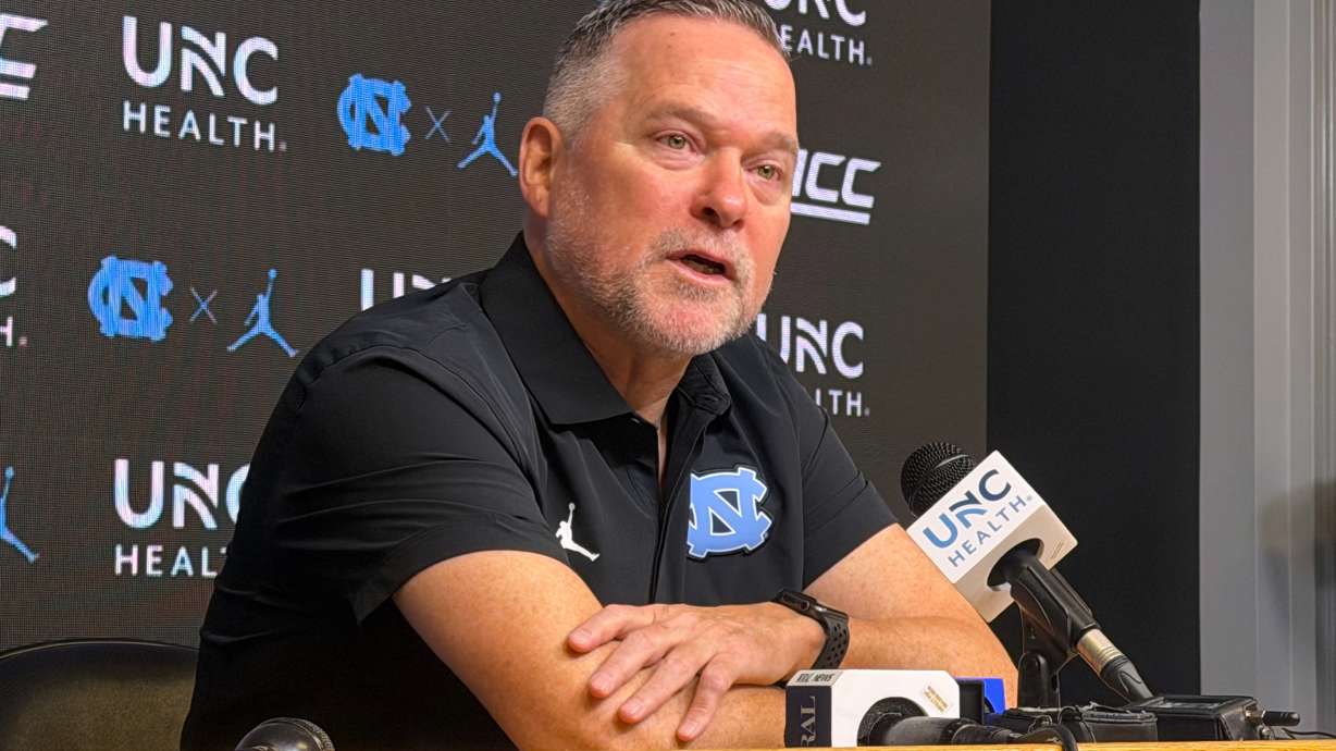 In this photo taken with a smartphone, North Carolina men's basketball head coach Michael Malone speaks during a news conference Thursday, Sept. 3, 2026, in Chapel Hill, N.C.