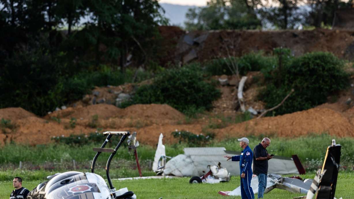 Authorities investigate a crash between a Pennsylvania State Police helicopter and a small plane at the Carlisle airport in Carlisle, Pennsylvania on August 19.