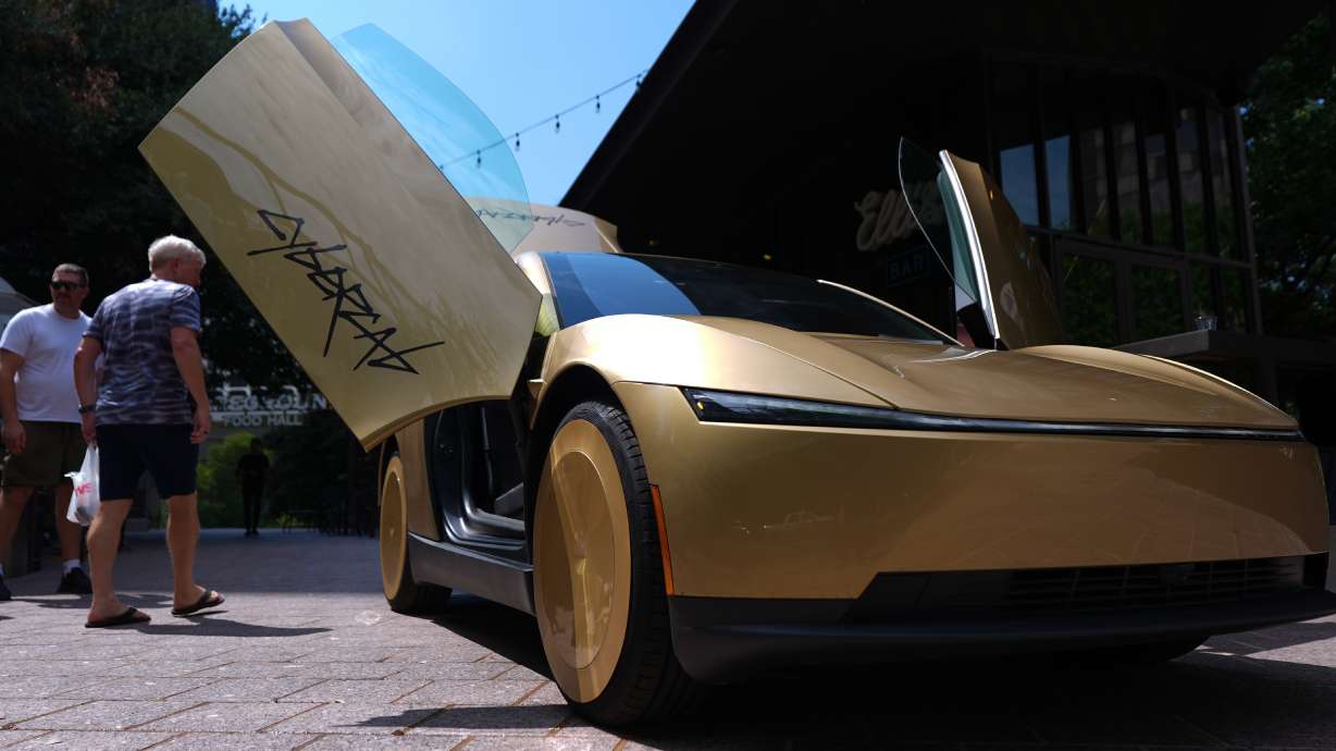A Tesla Cybercab is displayed in downtown Austin, Texas, Thursday. Elon Musk sent dozens of self-driving Cybercabs without steering wheels or brake pedals onto the streets, betting that Americans will overcome their fears of rides with "no control" and hop inside.
