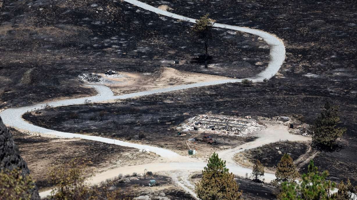 Debris from a burnt house is scattered after the Chelan Hills Fire burned through McNeil Canyon on Wednesday, July 8, 2026, in Orondo, Wash.