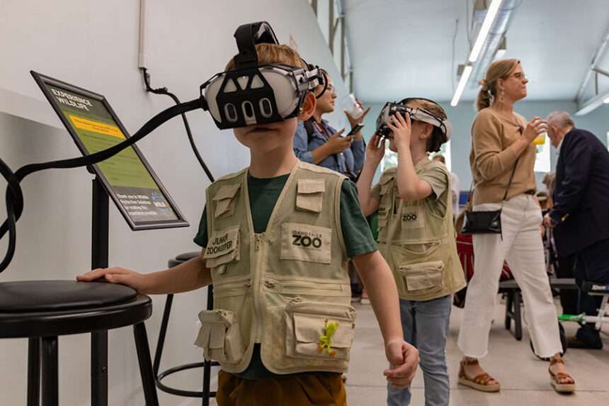 Theo Scheer and Levi Scheer interacting with the virtual reality headset at the Idaho Falls Zoo’s newest exhibit, the Islands.