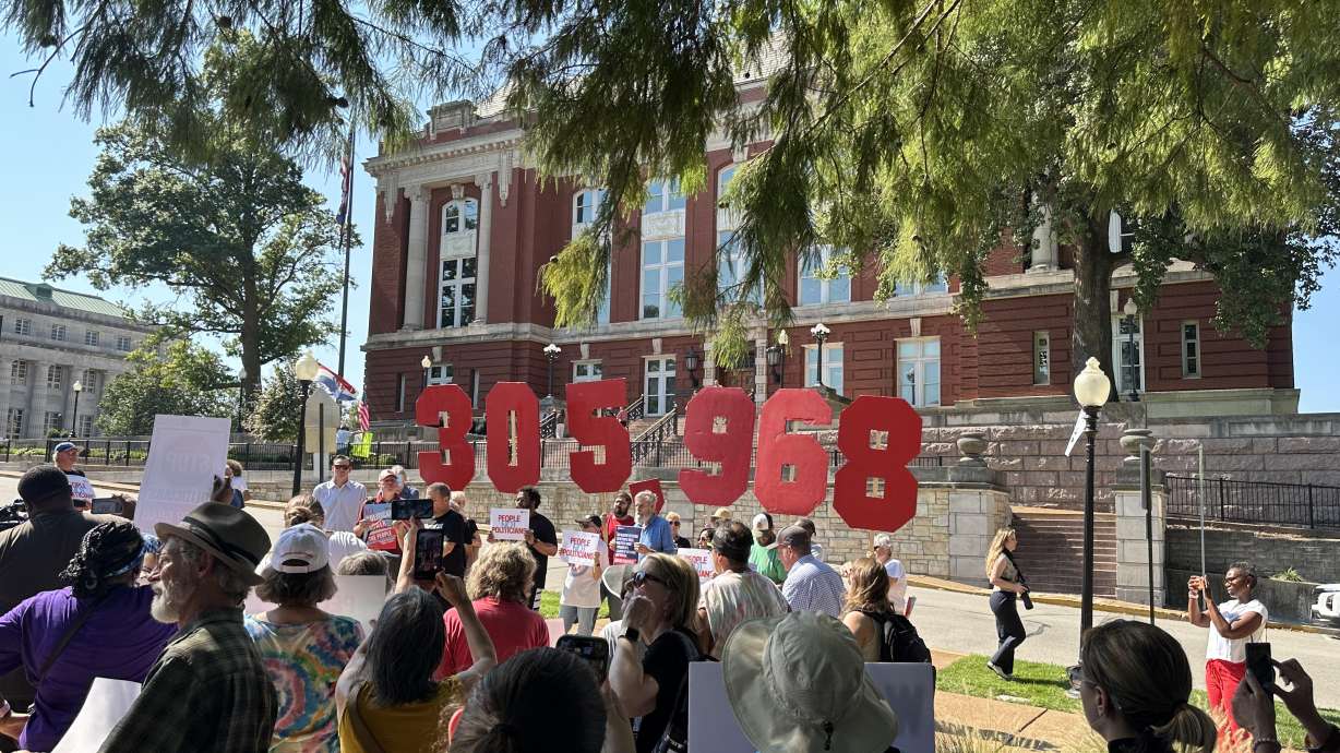 People opposing a congressional redistricting plan rally outside the Missouri Supreme Court in Jefferson City, Mo., Wednesday, while displaying the number of petition signatures submitted seeking a statewide vote on the measure. The court unanimously blocked the plan on Thursday.