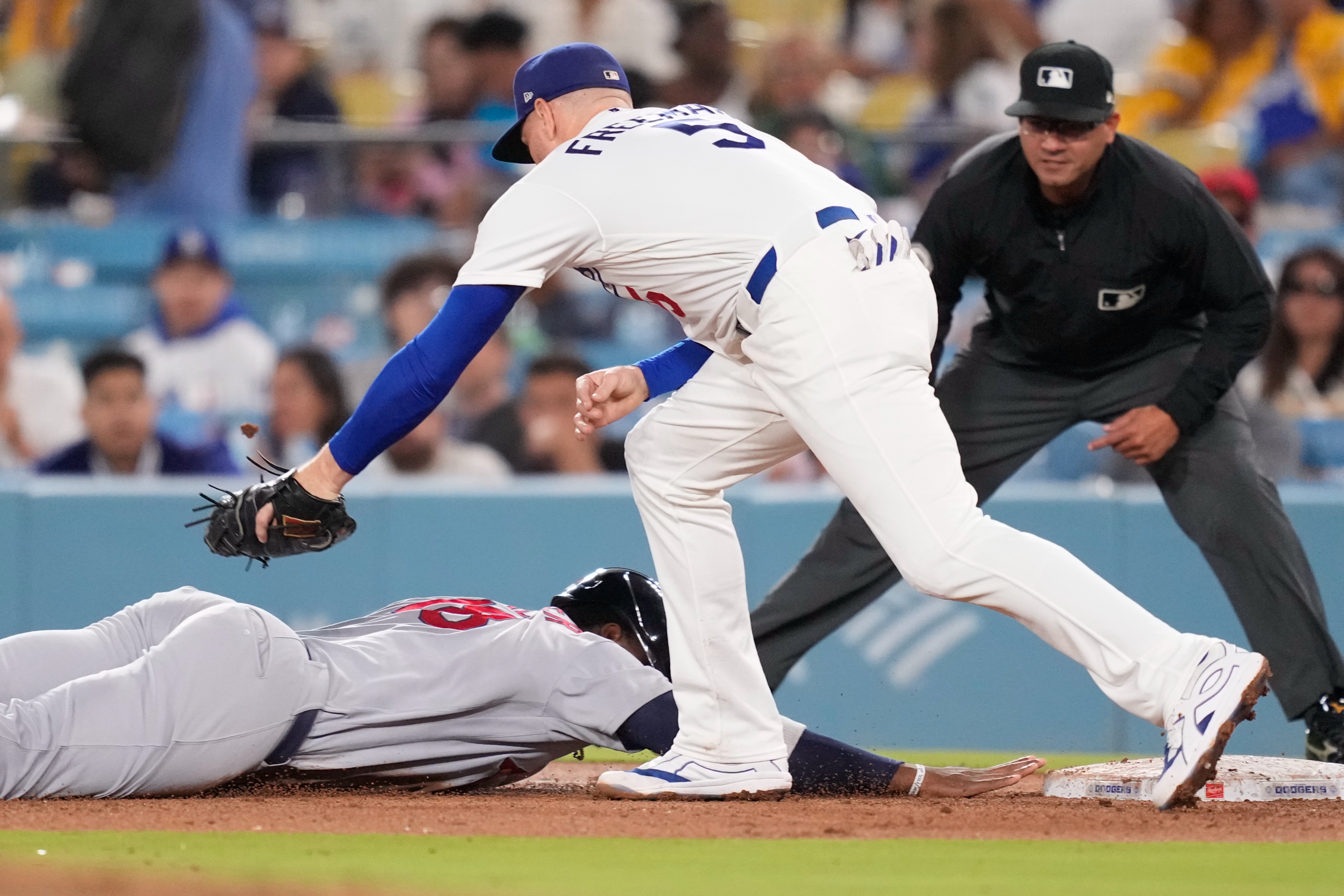 St. Louis Cardinals' Jordan Walker, left, is tagged out at first by Los Angeles Dodgers first baseman Freddie Freeman after being caught off base during the fifth inning of a baseball game Thursday, Sept. 3, 2026, in Los Angeles. 