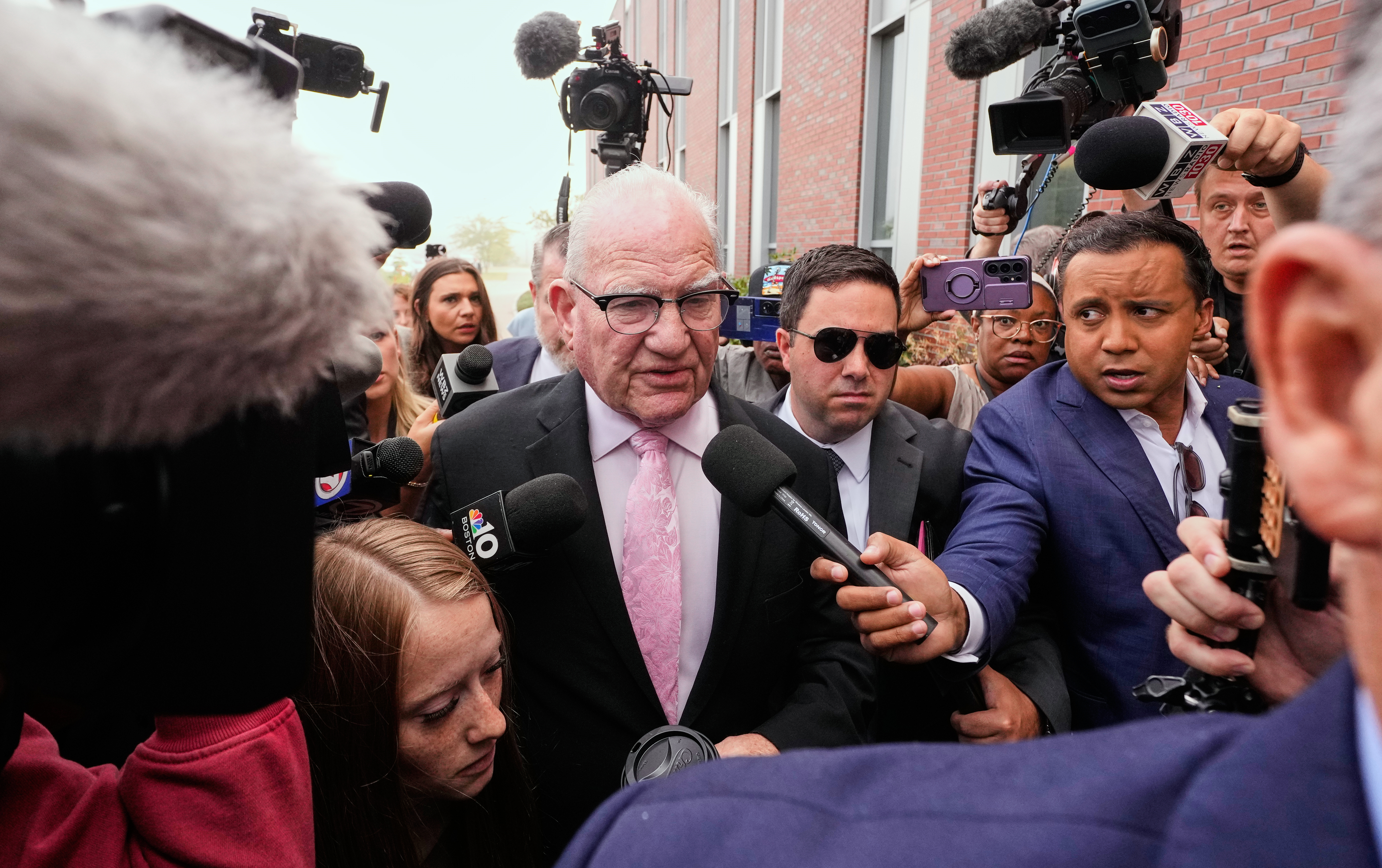 Kevin Reddington, defense attorney for Lindsay Clancy, walks through reporters and television cameras while arriving at Plymouth County Superior Court, Friday, in Plymouth, Mass. Reddington was allowed to file an appeal after Judge William Sullivan appeared ready to declare a mistrial.
