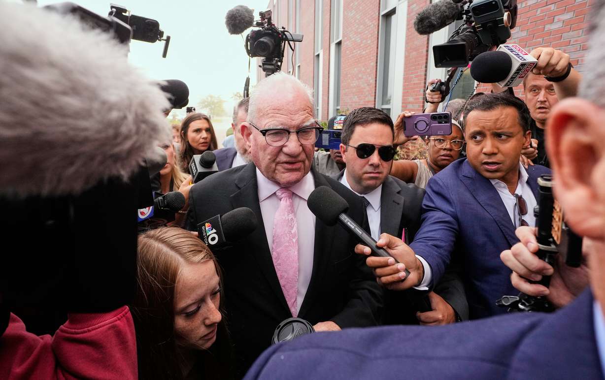 Kevin Reddington, defense attorney for Lindsay Clancy, walks through reporters and television cameras while arriving at Plymouth County Superior Court, Friday, in Plymouth, Mass. Reddington was allowed to file an appeal after Judge William Sullivan appeared ready to declare a mistrial.