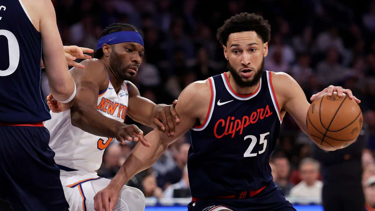 FILE - LA Clippers guard Ben Simmons drives past New York Knicks forward Precious Achiuwa during the first half of an NBA basketball game in New York, March 26, 2025.