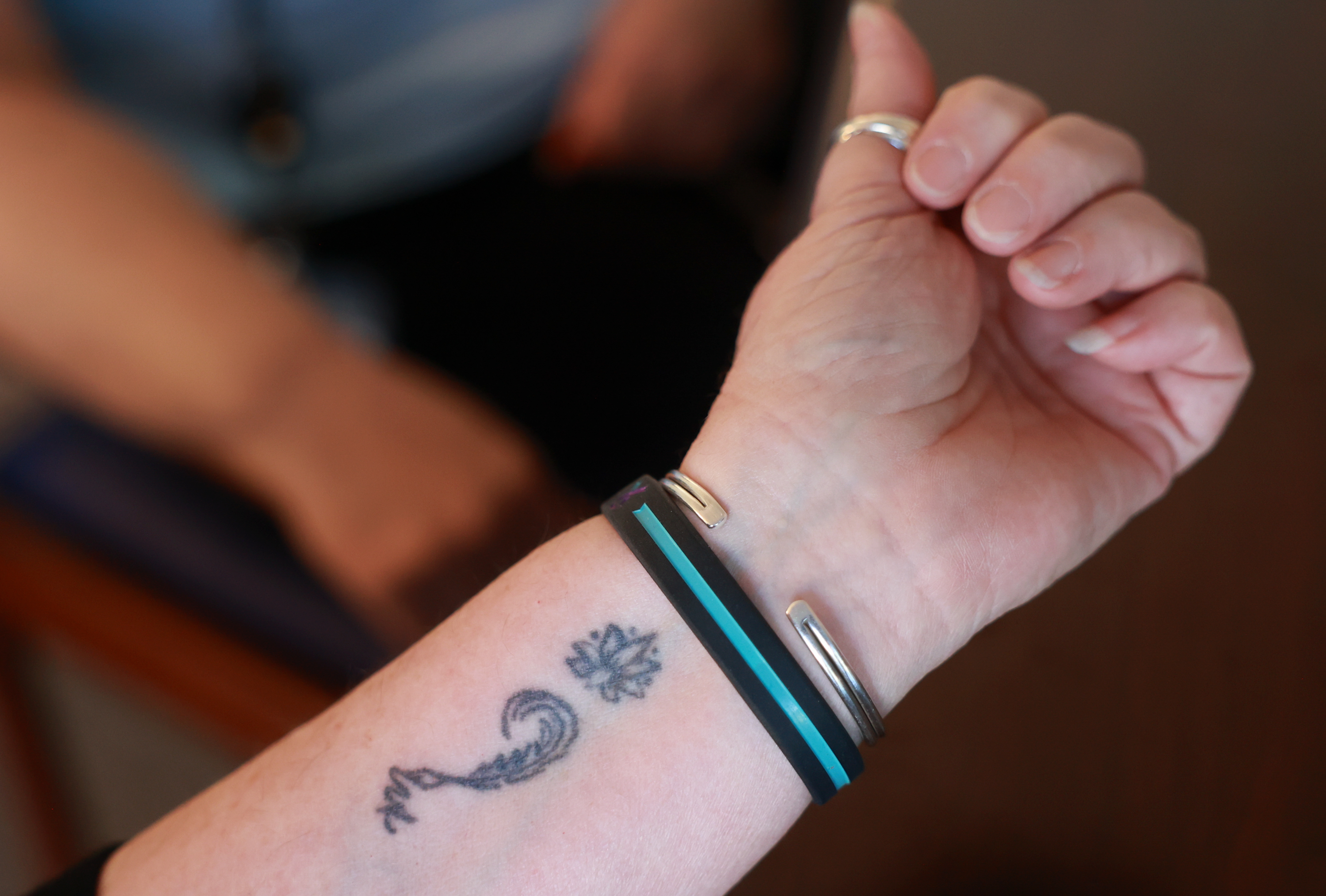 Salt Lake County tax lien coordinator Ray Lancaster, who lost her son to suicide, shows her semicolon tattoo, a symbol of suicide prevention and mental health awareness, in Salt Lake City on Thursday.