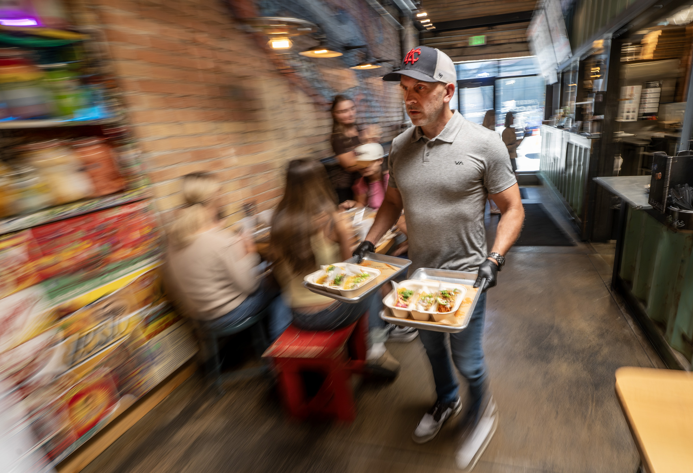 Co-owner Ryan Timmons brings a pair of orders to a table at ROCTACO in Salt Lake City on Friday. Five years after opening, Salt Lake City restaurant ROCTACO is looking to expand — if the fit is right.