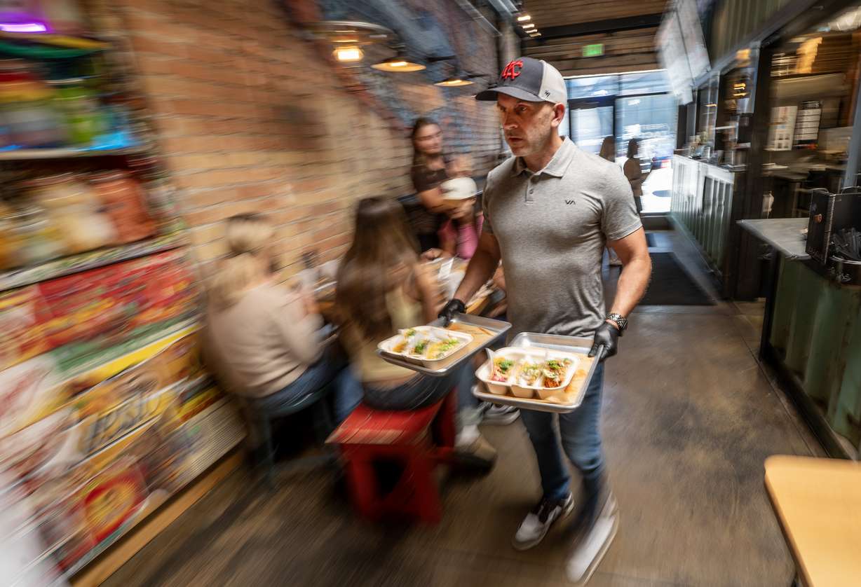 Co-owner Ryan Timmons brings a pair of orders to a table at ROCTACO in Salt Lake City on Friday. Five years after opening, Salt Lake City restaurant ROCTACO is looking to expand — if the fit is right.