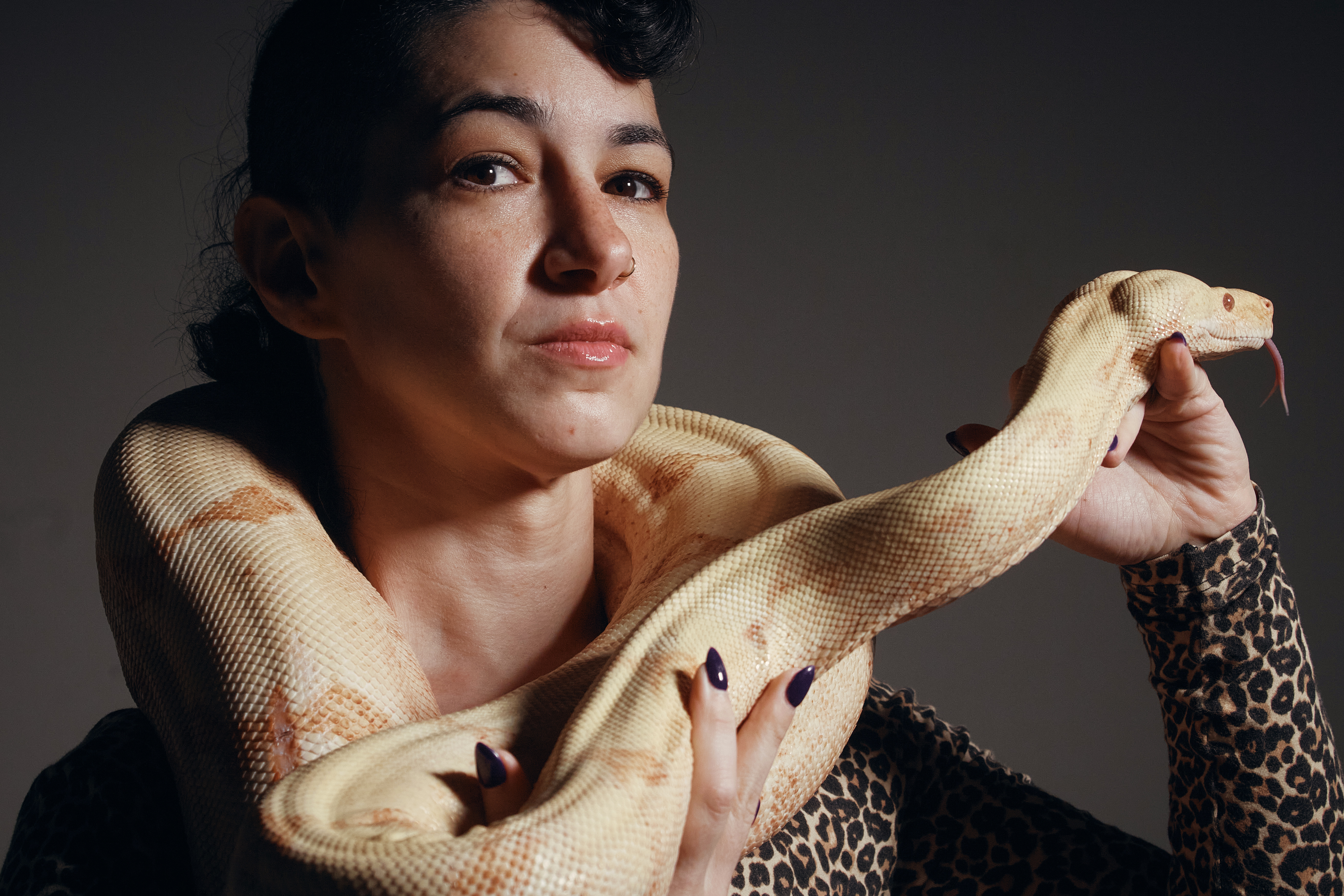 Performance artist Zoe Ziegfeld who plays the part of a snake charmer poses for a portrait with a snake during auditions to select a snake for a part in an adaptation of Mozart’s “Così fan tutte," at the Metropolitan Opera in New York, Aug. 28.