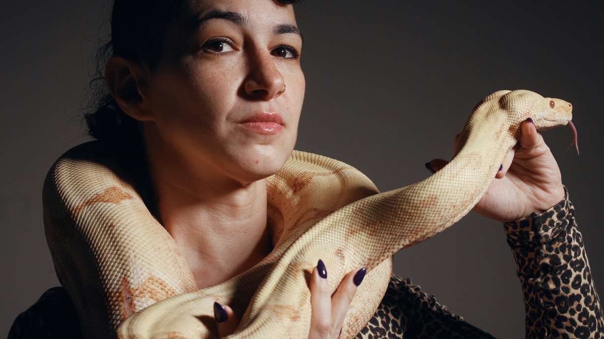 Performance artist Zoe Ziegfeld who plays the part of a snake charmer poses for a portrait with a snake during auditions to select a snake for a part in an adaptation of Mozart’s “Così fan tutte," at the Metropolitan Opera in New York, Aug. 28.