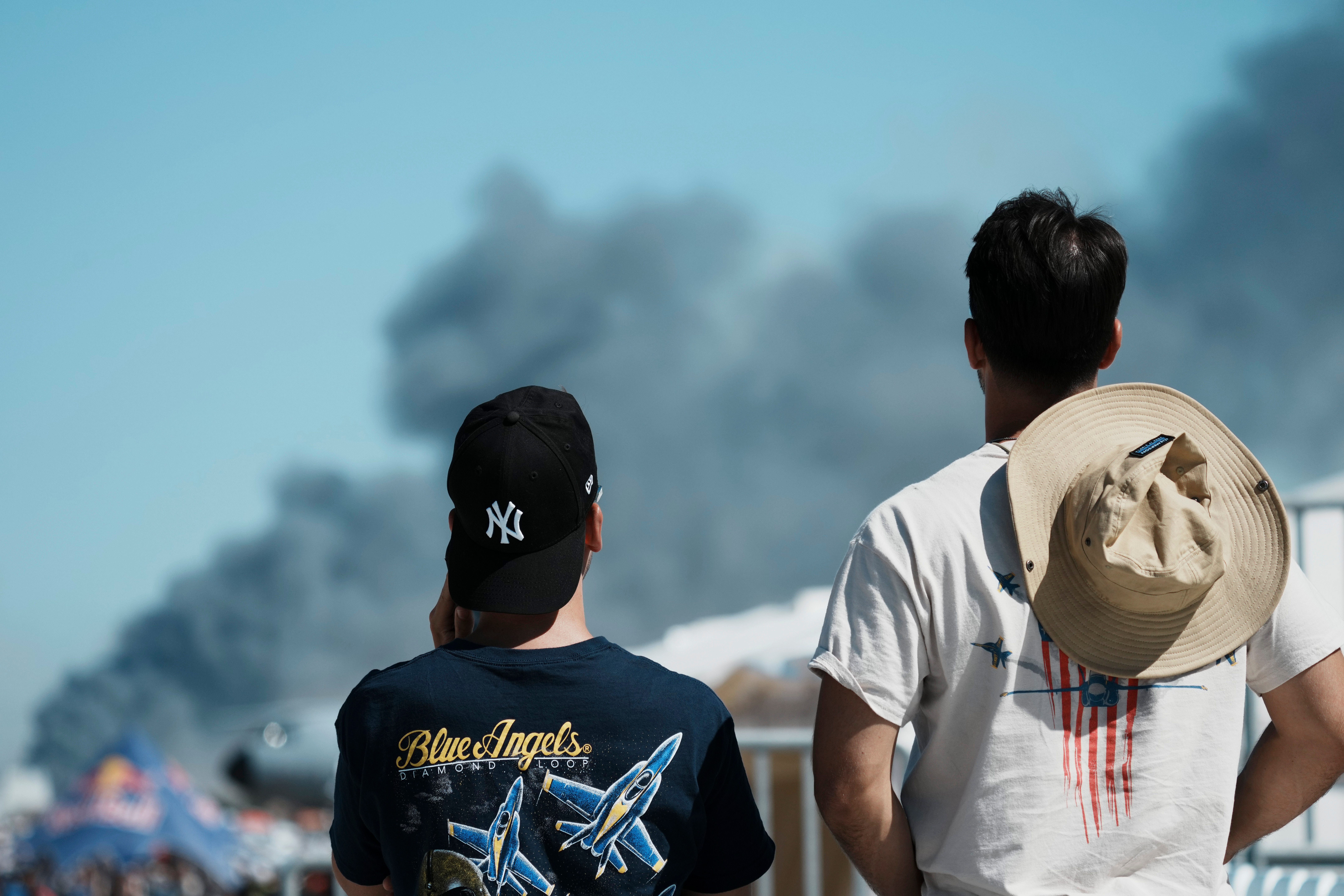 Spectators watch as smoke rises after a Hellenic Air Force F-4 Phantom fighter jet crashed, during the Athens Flying Week airshow at Tanagra Air Force Base, north of Athens, Greece, Saturday. Both pilots of the jet were killed.