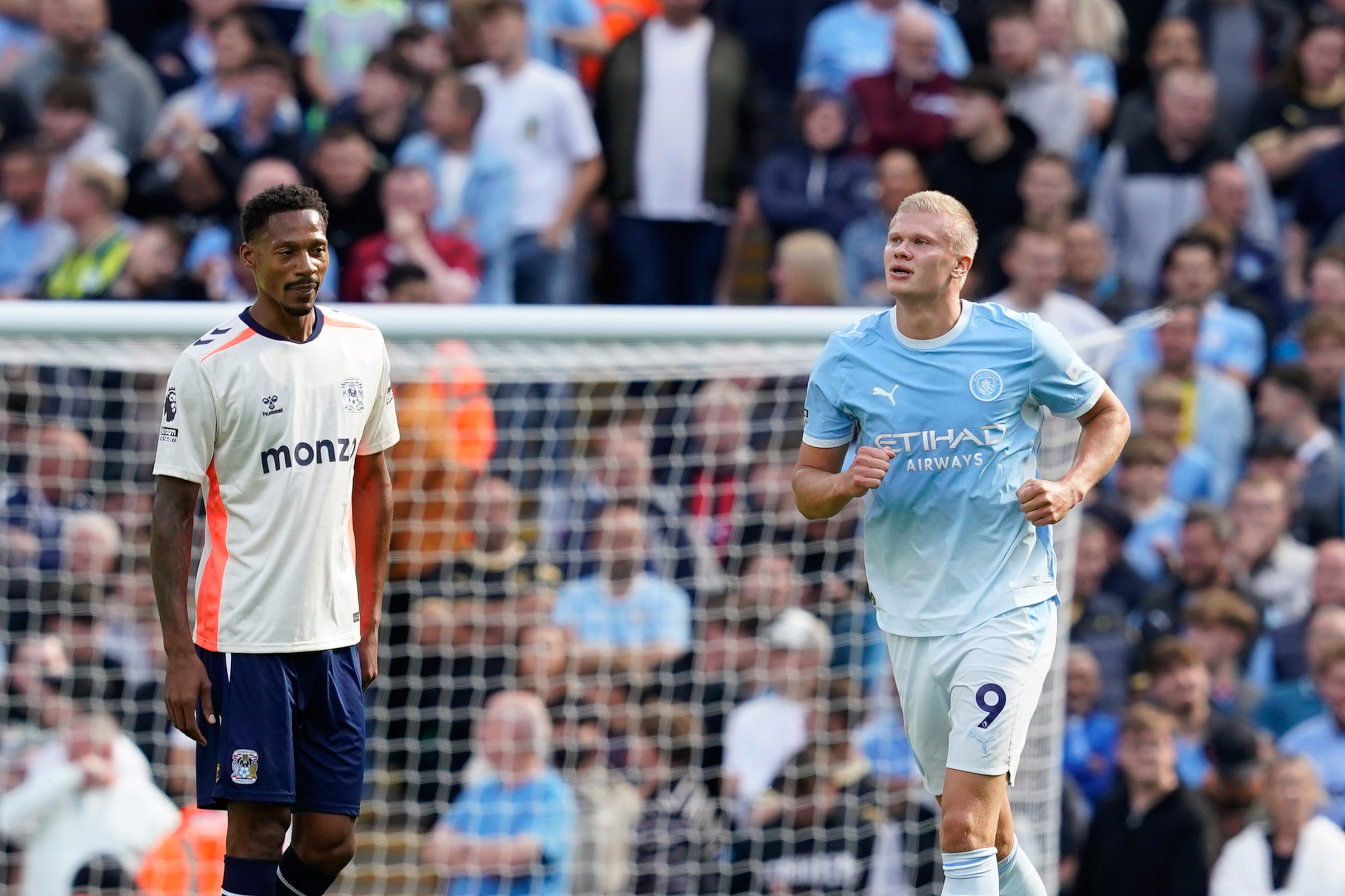 Manchester City's Erling Haaland, right, celebrates after scoring his side's opening goal during the English Premier League soccer match between Manchester City and Coventry City in Manchester, England, Saturday, Sept. 5, 2026. 
