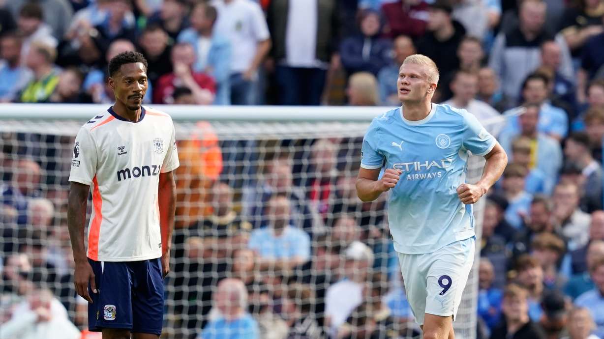 Manchester City's Erling Haaland, right, celebrates after scoring his side's opening goal during the English Premier League soccer match between Manchester City and Coventry City in Manchester, England, Saturday, Sept. 5, 2026.