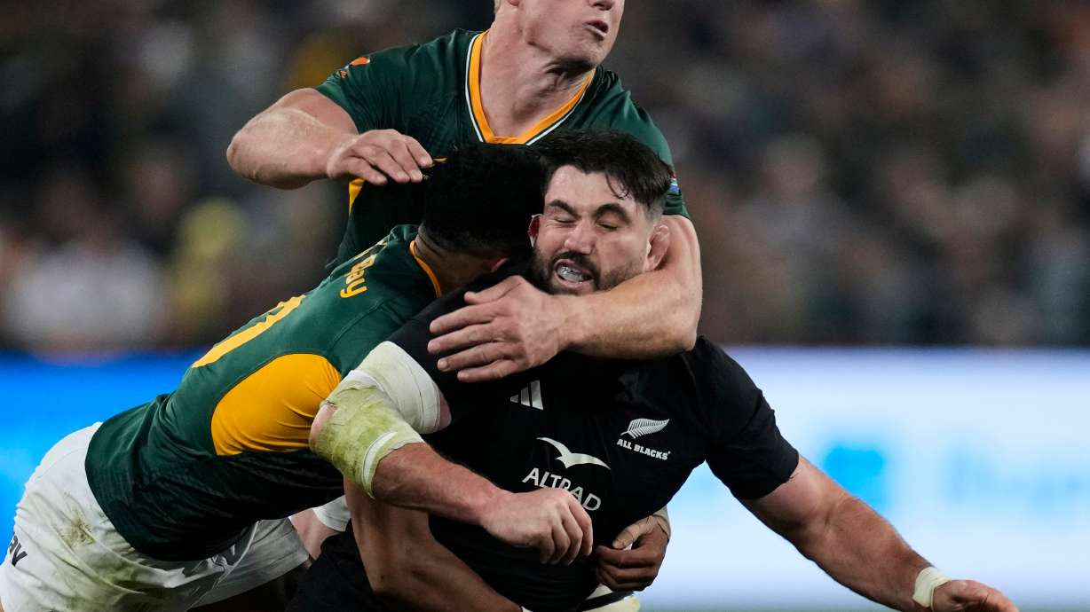 New Zealand's Luke Jacobson, right, is tackled by South Africa's Sacha Feinberg-Mngomezulu, left, and his teammate Pieter-Steph du Toit, during a third international test rugby match between South Africa and New Zealand, in Johannesburg, South Africa, Saturday, Sept. 5, 2026.