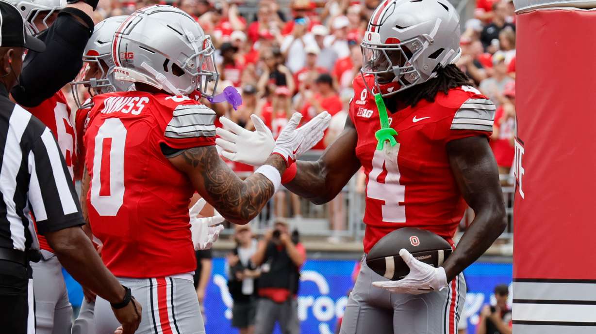 Ohio State wide receiver Jeremiah Smith, right, celebrates his touchdown reception against Ball State with teammate Brandon Inniss during the first half of an NCAA college football game, Saturday, Sept. 5, 2026, in Columbus, Ohio.