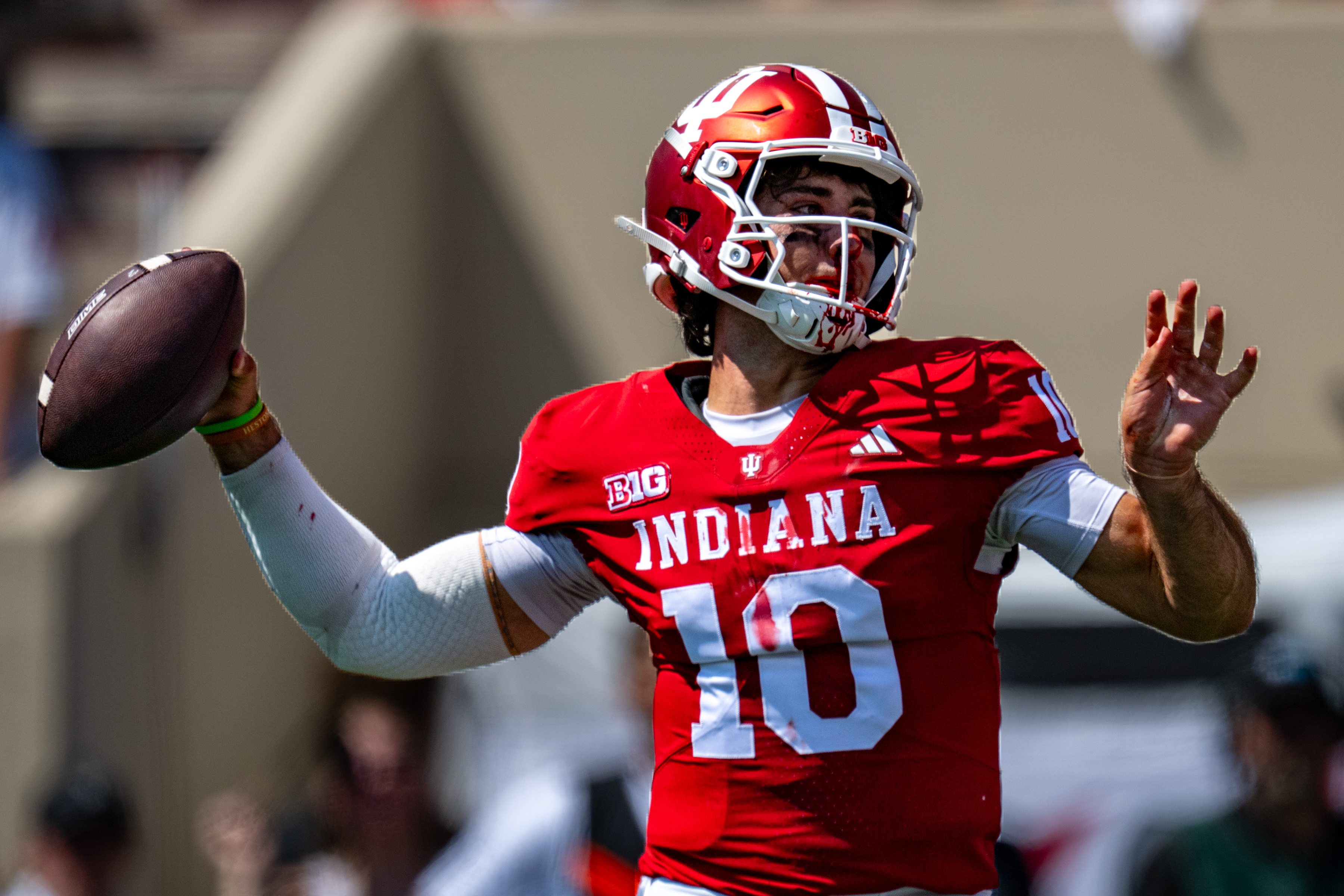 A bloodied Indiana quarterback Josh Hoover (10) looks to pass during the first half of an NCAA college football game against North Texas, Saturday, Sept. 5, 2026, in Bloomington, Ind. 