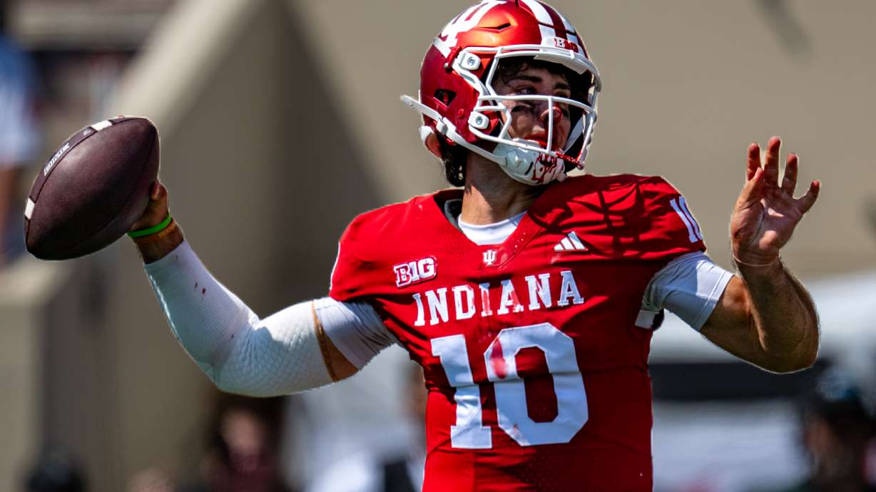A bloodied Indiana quarterback Josh Hoover (10) looks to pass during the first half of an NCAA college football game against North Texas, Saturday, Sept. 5, 2026, in Bloomington, Ind.